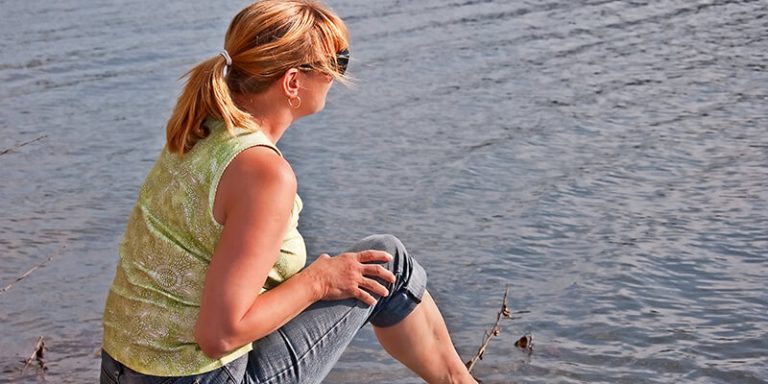 Woman Looking Over The Lake