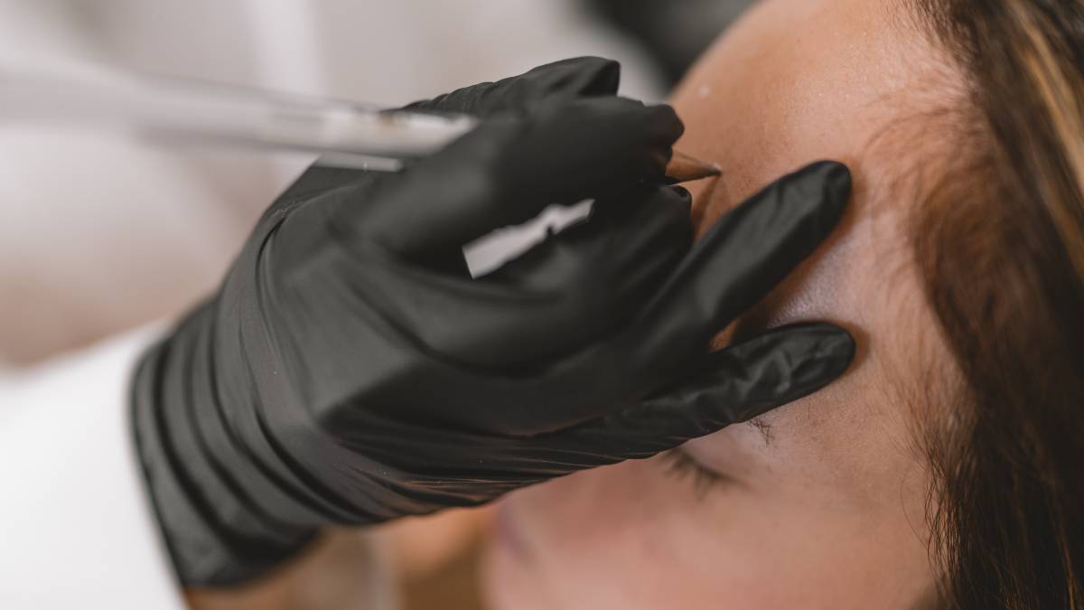 lady getting marked on her forehead